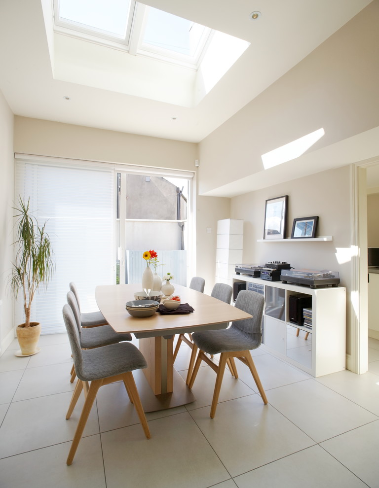 This is an example of a contemporary dining room in Dublin with beige walls.