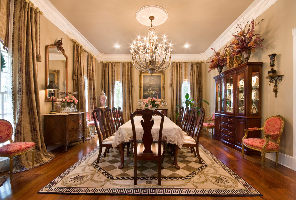 Large classic dining room in New Orleans with beige walls and medium hardwood flooring.
