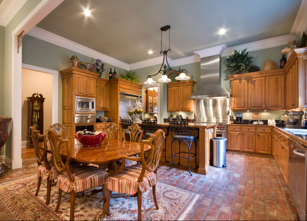 Example of a large classic brick floor kitchen/dining room combo design in New Orleans
