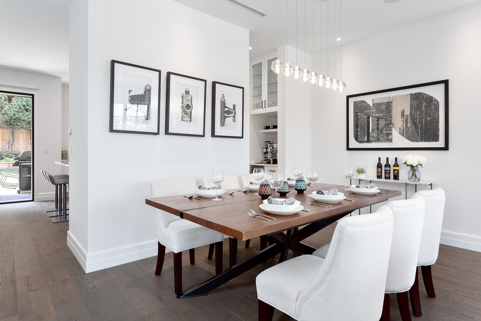 Mid-sized transitional brown floor and dark wood floor dining room photo in Vancouver with white walls