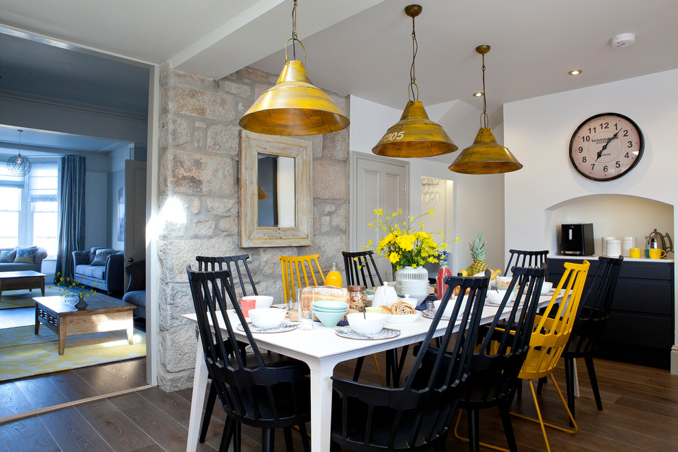 Nautical dining room in Cornwall with dark hardwood flooring and white walls.