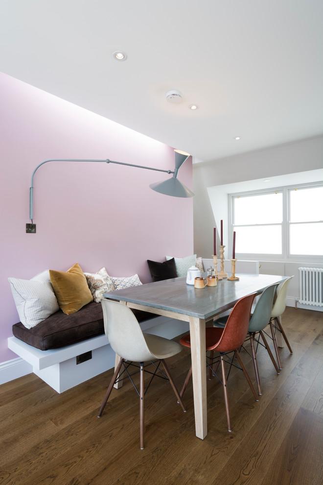 Inspiration for a contemporary dining room in London with pink walls and medium hardwood flooring.
