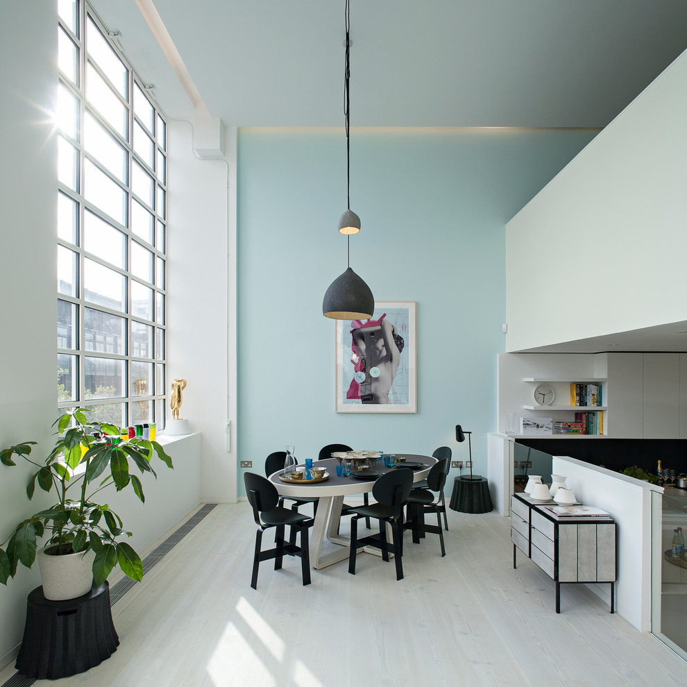 Great room - scandinavian light wood floor great room idea in London with blue walls