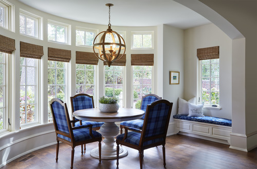 blue checkered chairs and round farmhouse style chandelier light in dining room
