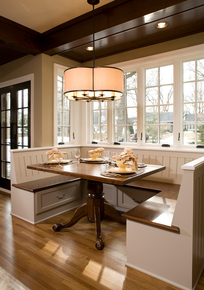 Traditional dining room in Minneapolis with beige walls and medium hardwood flooring.