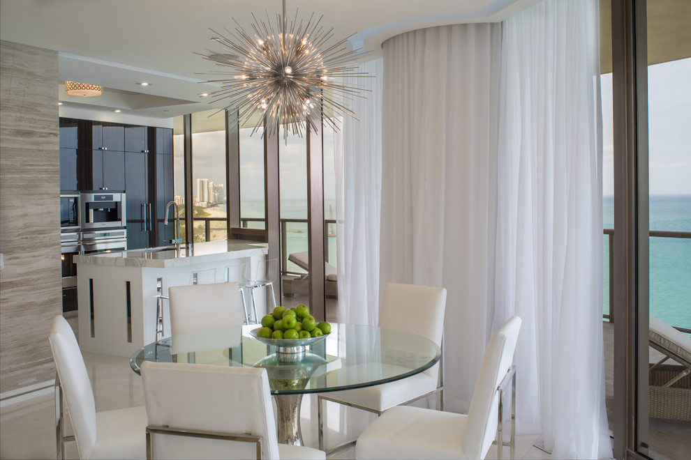 Medium sized contemporary kitchen/dining room in Miami with marble flooring, a ribbon fireplace, a stone fireplace surround and white floors.