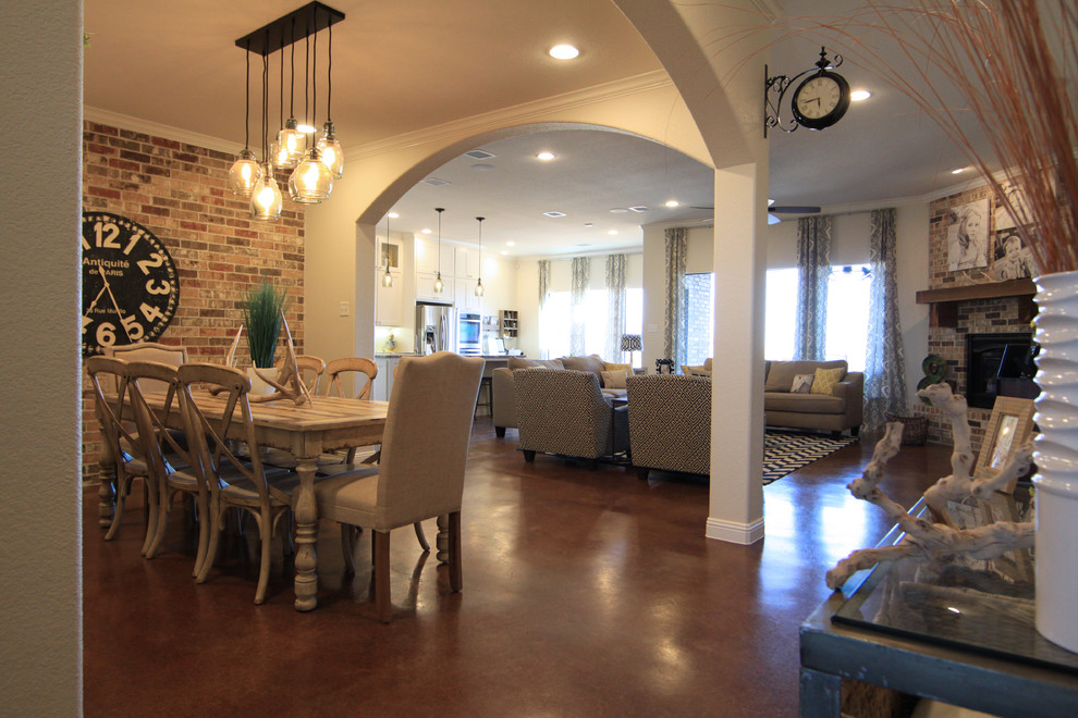 На фото: кухня-столовая среднего размера в стиле неоклассика (современная классика) с бежевыми стенами, бетонным полом, угловым камином и фасадом камина из кирпича с