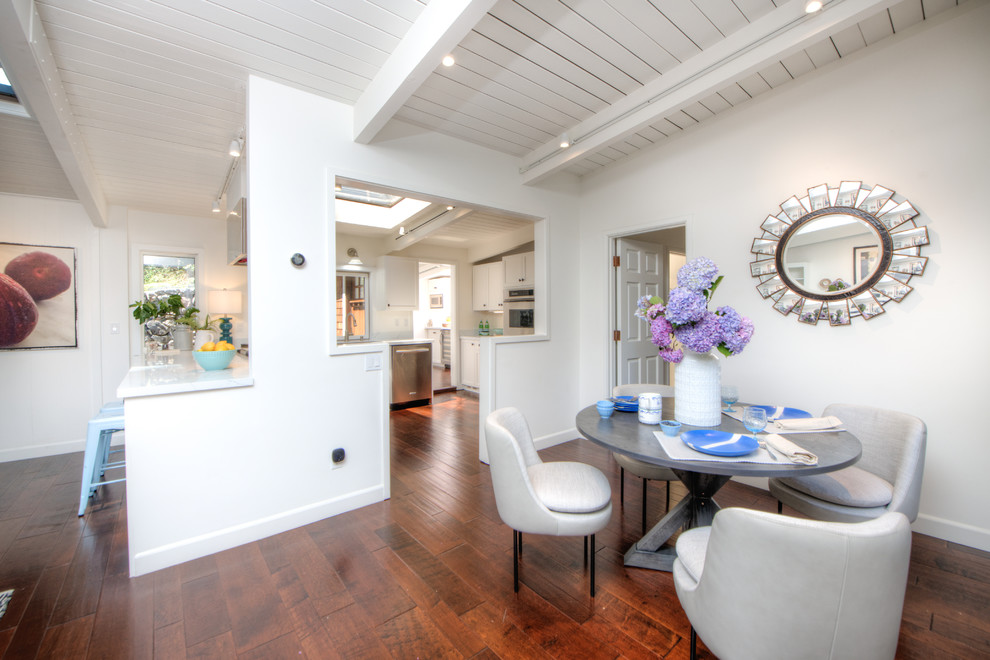 Example of a mid-sized transitional medium tone wood floor and brown floor great room design in San Francisco with white walls and no fireplace