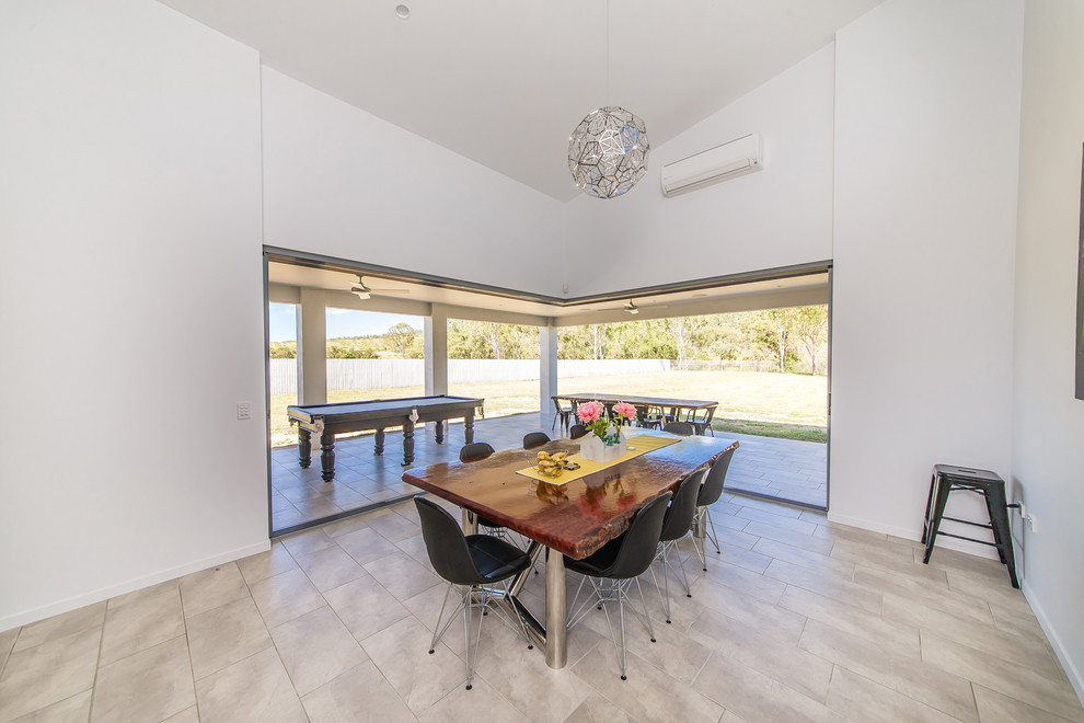 Example of a minimalist dining room design in Brisbane