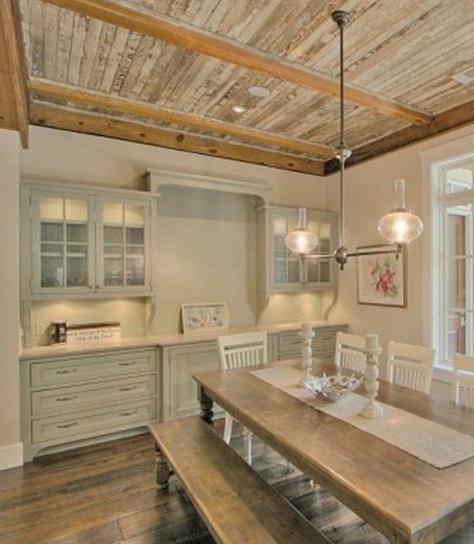 Example of a mid-sized cottage chic medium tone wood floor and brown floor enclosed dining room design in Atlanta with beige walls