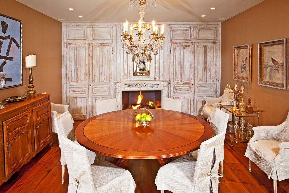 Cette image montre une salle à manger méditerranéenne avec un mur marron, parquet foncé, une cheminée standard et un manteau de cheminée en bois.
