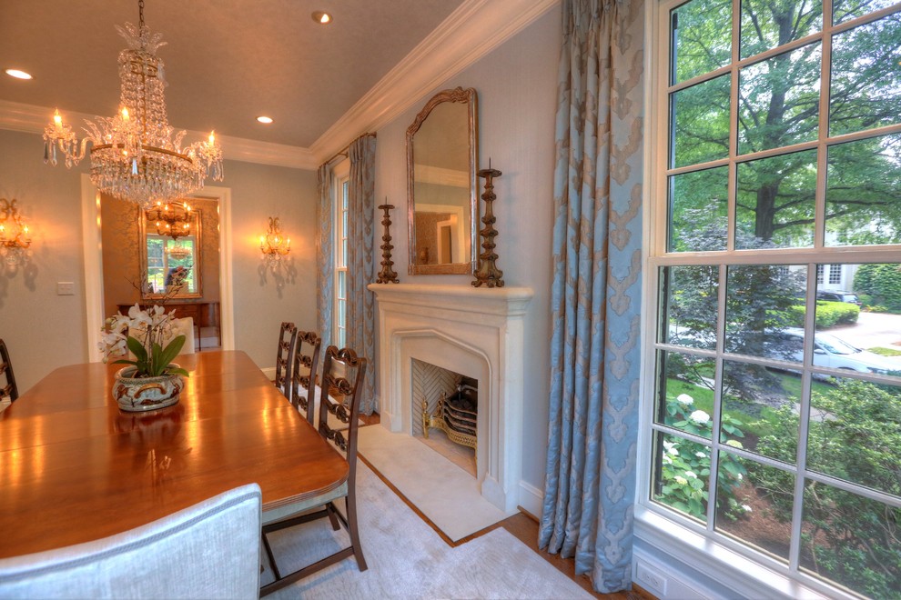 Inspiration for a dining room remodel in Other with a hanging fireplace and a stone fireplace