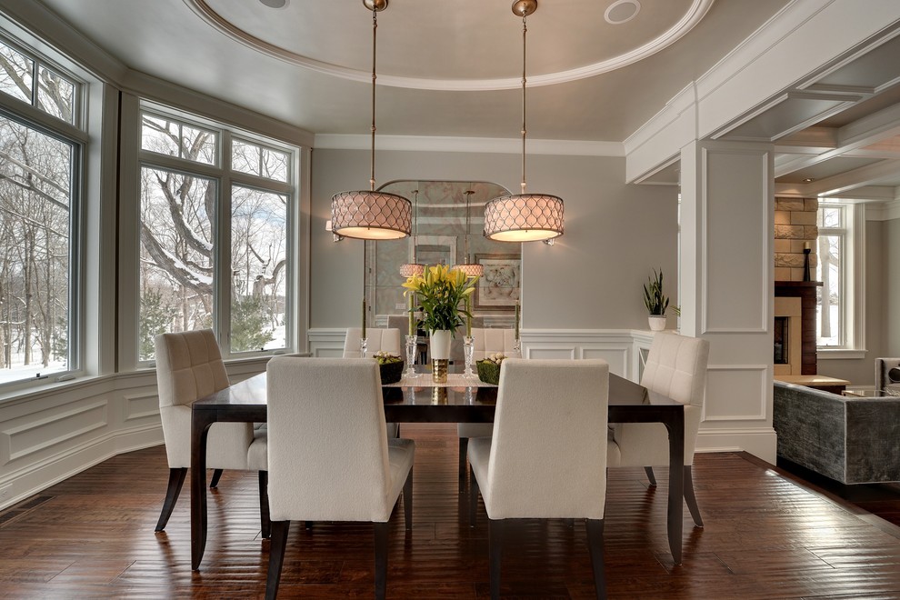 Elegant dark wood floor and brown floor dining room photo in Minneapolis with gray walls