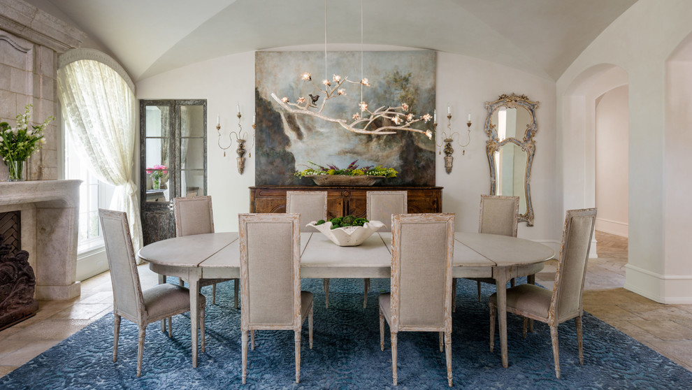 Medium sized mediterranean enclosed dining room in Houston with limestone flooring, a standard fireplace, a stone fireplace surround and white walls.