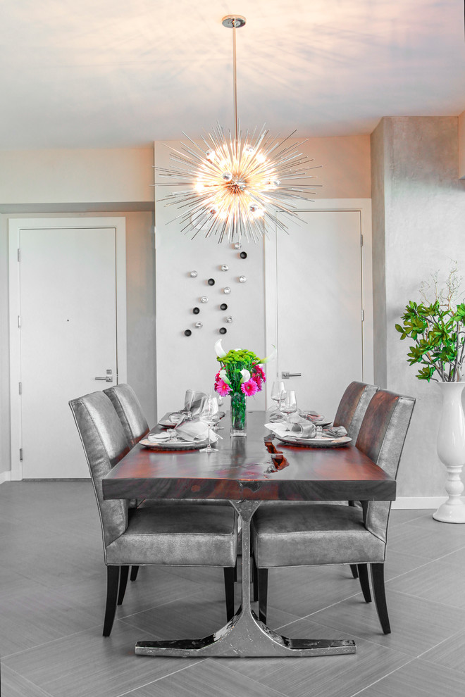 Idée de décoration pour une salle à manger design avec un mur gris et un sol gris.