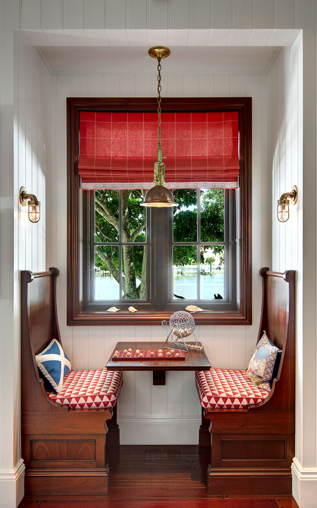 Example of a small beach style dark wood floor kitchen/dining room combo design in Miami with white walls