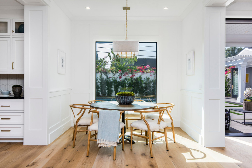 Inspiration for a coastal light wood floor and beige floor dining room remodel in Los Angeles with white walls