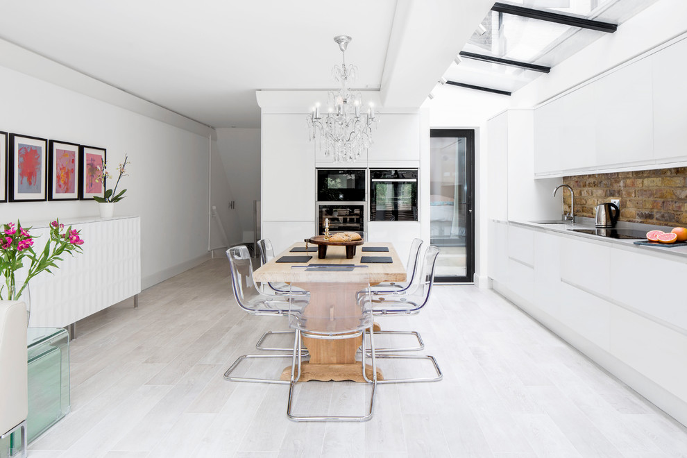Inspiration for a contemporary kitchen/dining room in London with white walls and painted wood flooring.