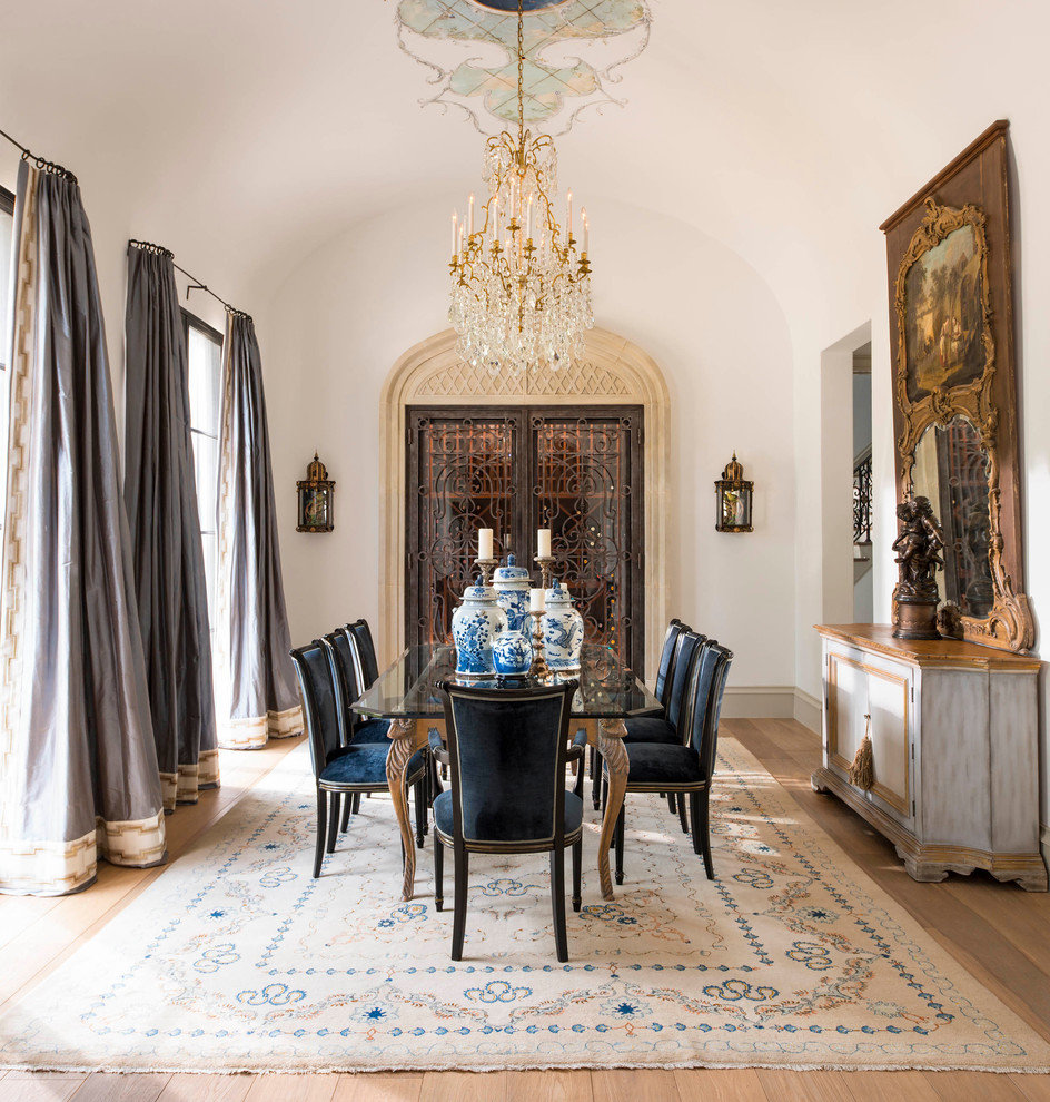 Imagen de comedor clásico cerrado con paredes blancas, suelo de madera clara y cortinas
