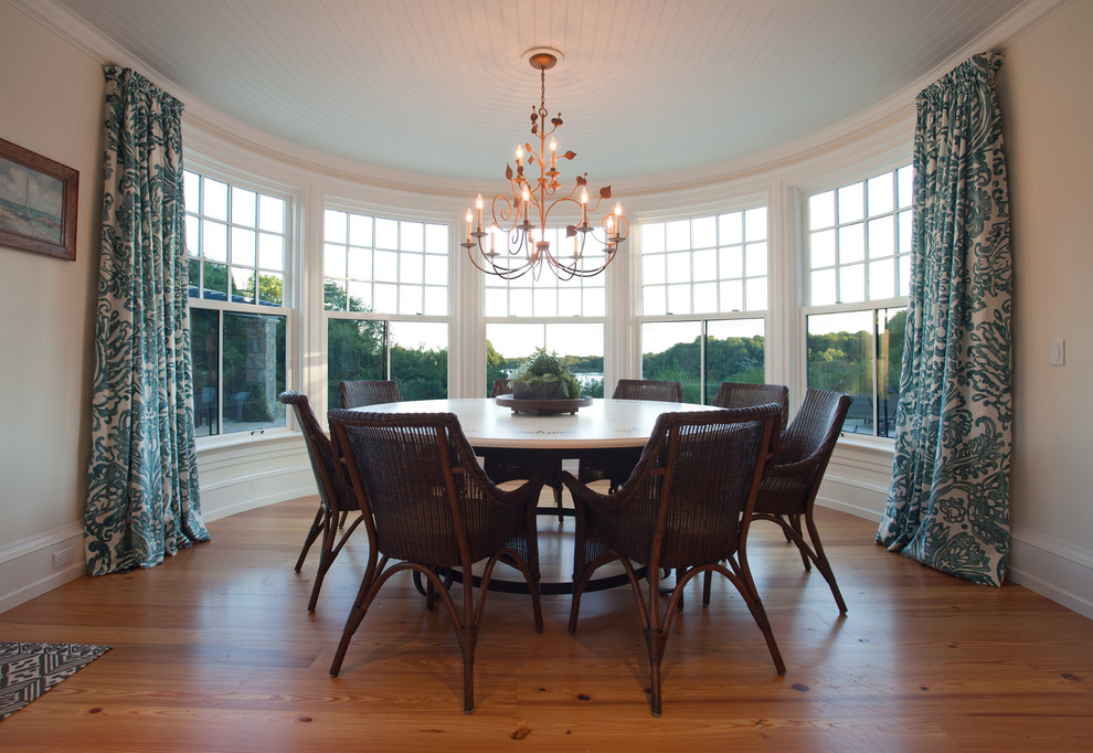 Example of a mid-sized beach style light wood floor and brown floor enclosed dining room design in Providence with beige walls and no fireplace