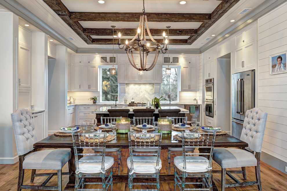 Example of a mid-sized beach style medium tone wood floor kitchen/dining room combo design in Charleston with white walls