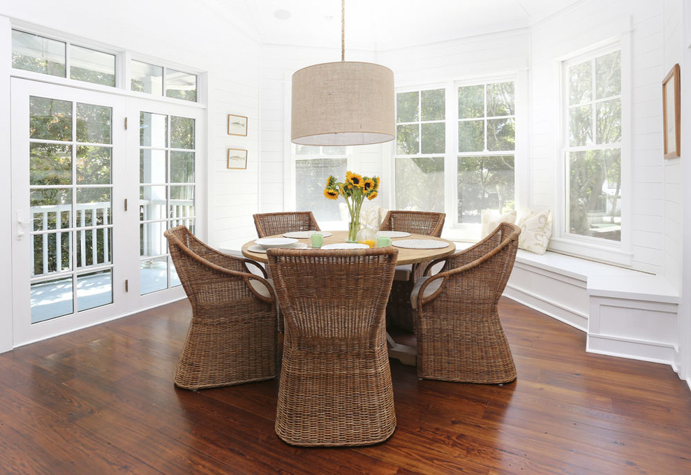 Photo of a nautical dining room in Charleston with white walls and dark hardwood flooring.