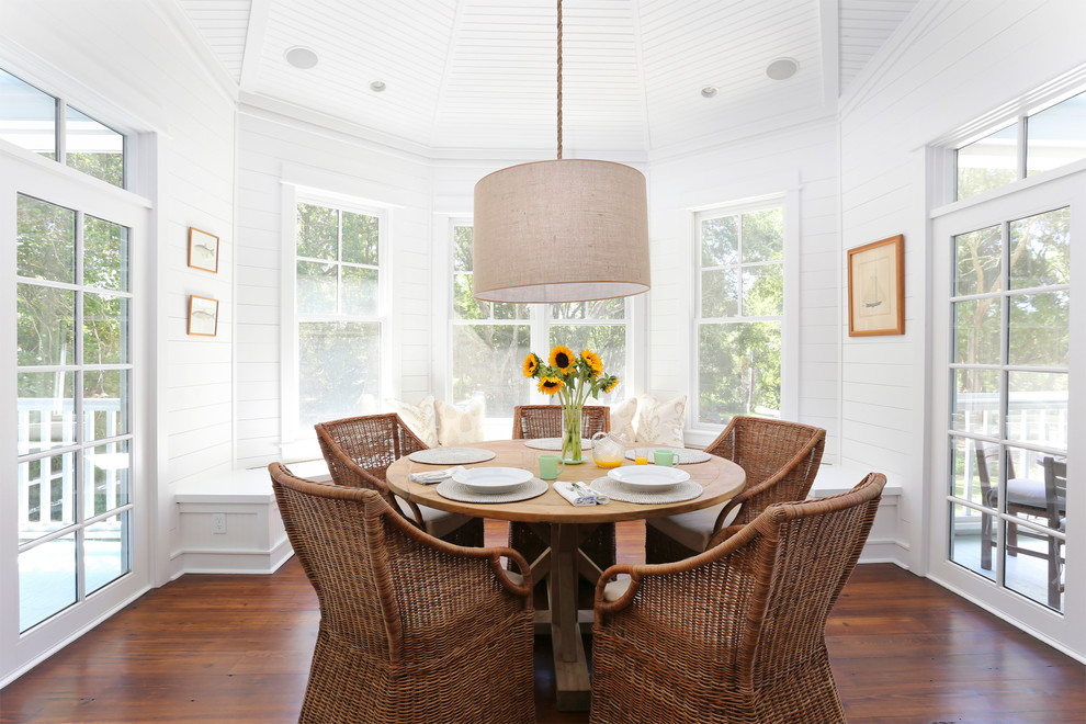 This is an example of a beach style dining room in Charleston with white walls.