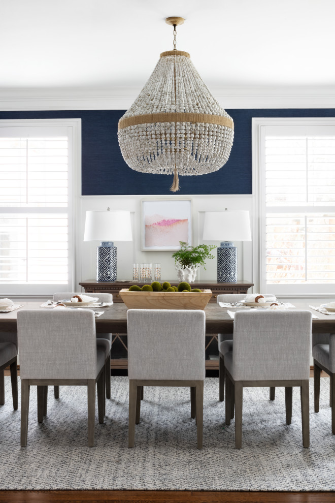 Example of a beach style medium tone wood floor, brown floor and wallpaper dining room design in DC Metro with blue walls