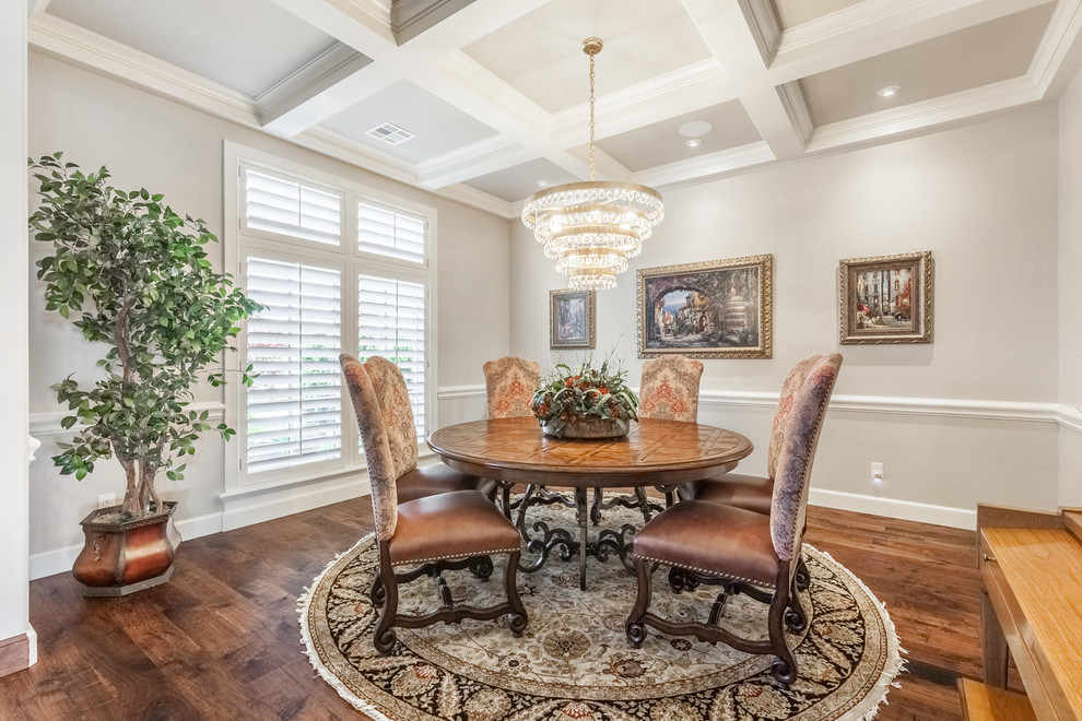 Inspiration for a small timeless medium tone wood floor and brown floor enclosed dining room remodel in Oklahoma City with gray walls and no fireplace