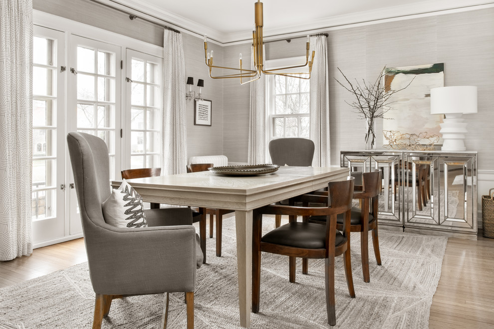 Classic dining room in Milwaukee with grey walls, light hardwood flooring and beige floors.