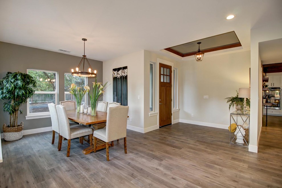 This is an example of a medium sized classic enclosed dining room in Sacramento with beige walls, laminate floors and grey floors.
