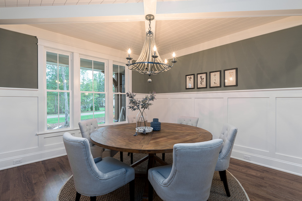 Traditional enclosed dining room in Raleigh with green walls, dark hardwood flooring and brown floors.