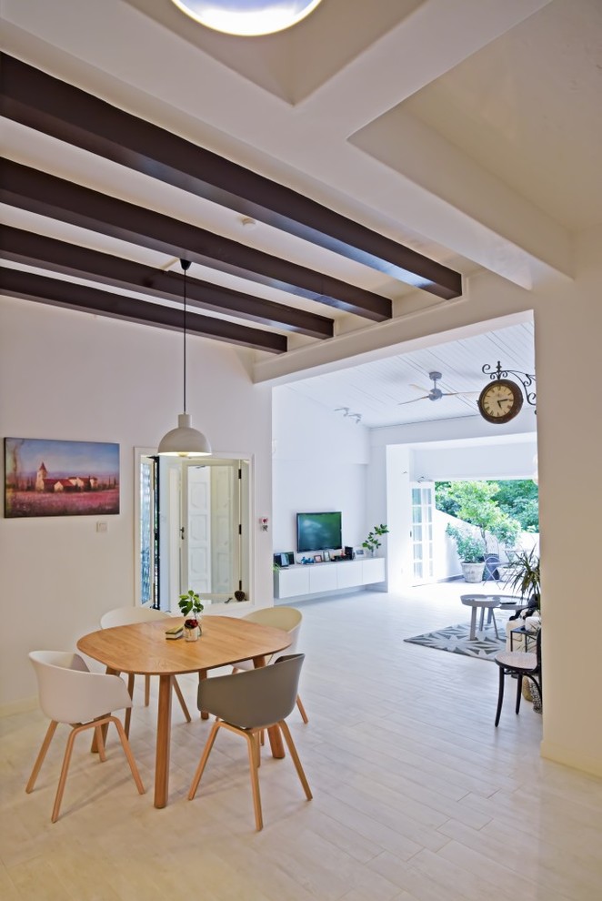 Contemporary open plan dining room in Singapore with white walls and light hardwood flooring.
