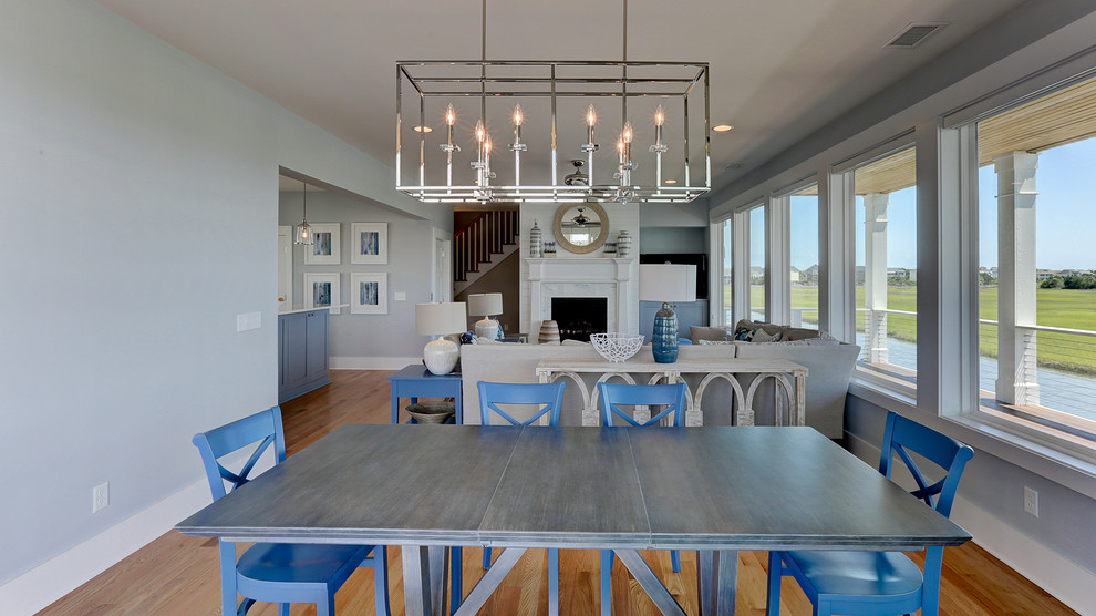 Idee per una sala da pranzo stile marinaro con pareti blu, parquet chiaro e pavimento marrone