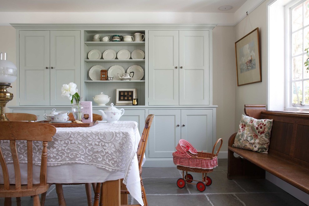 Example of a country dining room design in Surrey with beige walls