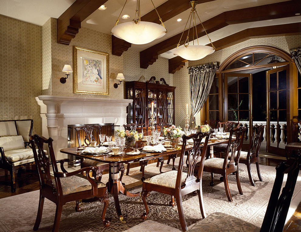 Dining room - large victorian dark wood floor dining room idea in Los Angeles with a standard fireplace