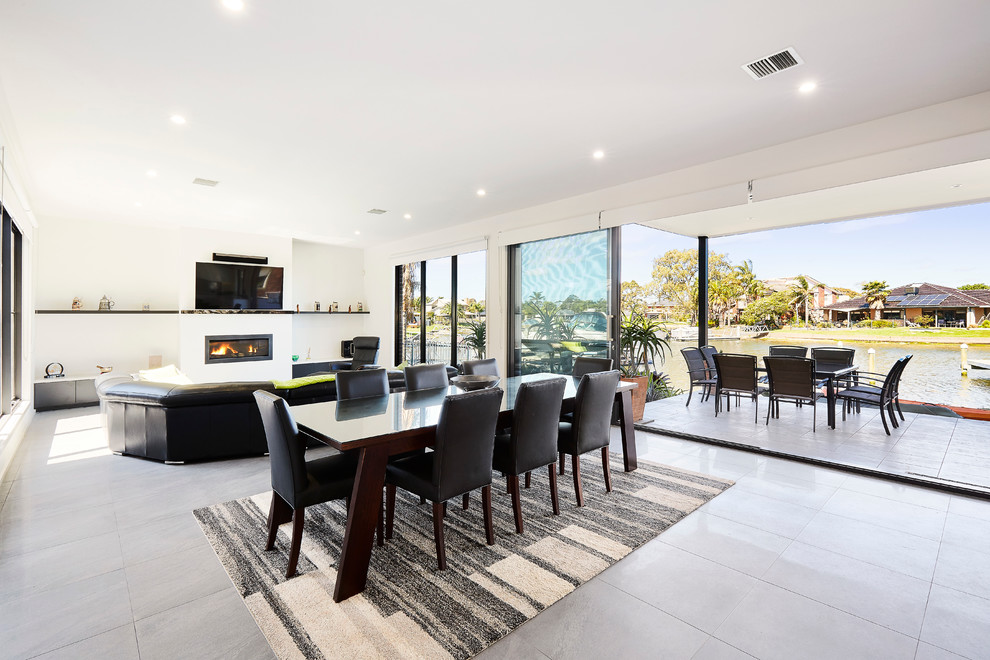 Mid-sized minimalist ceramic tile kitchen/dining room combo photo in Melbourne with white walls
