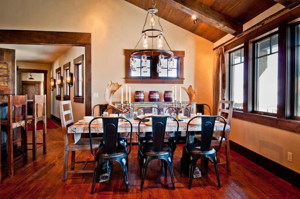This is an example of a medium sized rustic open plan dining room in Denver with beige walls and medium hardwood flooring.