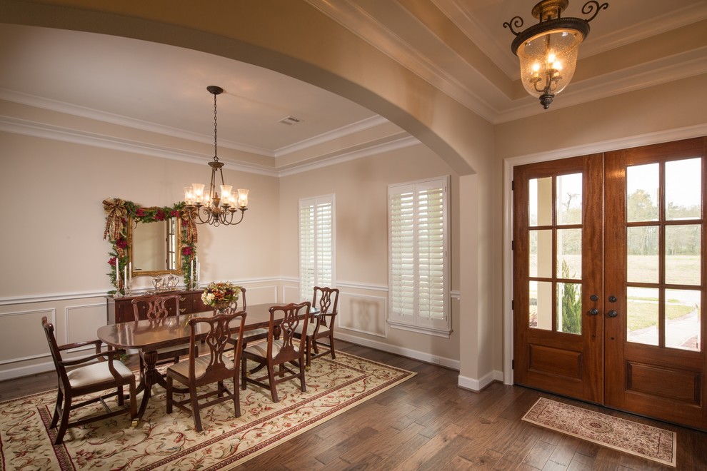 Dining room - mid-sized traditional medium tone wood floor dining room idea in Houston with beige walls