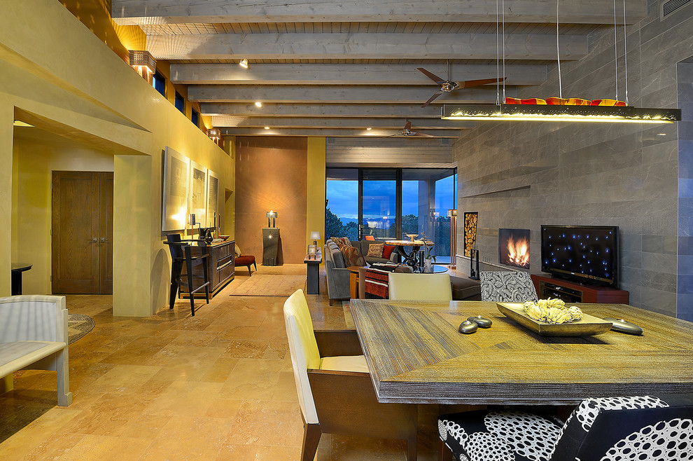 На фото: гостиная-столовая среднего размера в стиле модернизм с серыми стенами, полом из известняка, стандартным камином, фасадом камина из плитки и бежевым полом с