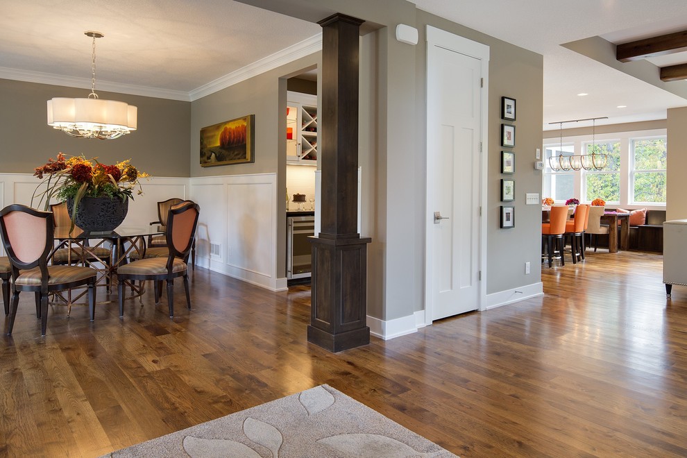 Example of a large transitional medium tone wood floor enclosed dining room design in Minneapolis with beige walls and no fireplace