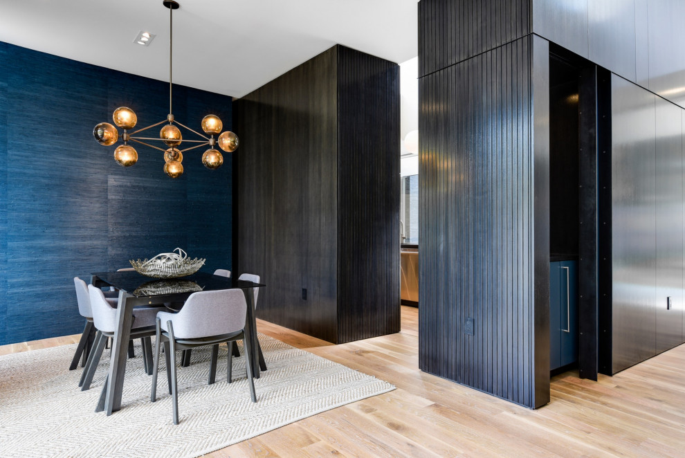 Example of a mid-sized minimalist medium tone wood floor and beige floor kitchen/dining room combo design in Austin with blue walls