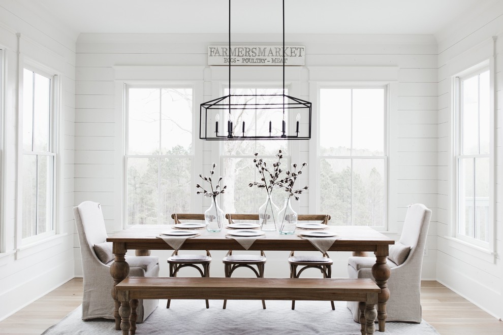 Inspiration for a farmhouse dining room in Atlanta with white walls, light hardwood flooring and no fireplace.