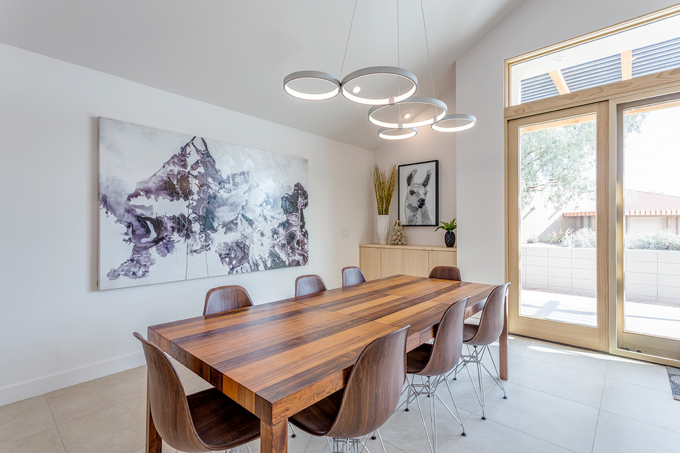 This is an example of a contemporary dining room in Phoenix with porcelain flooring, beige floors and white walls.