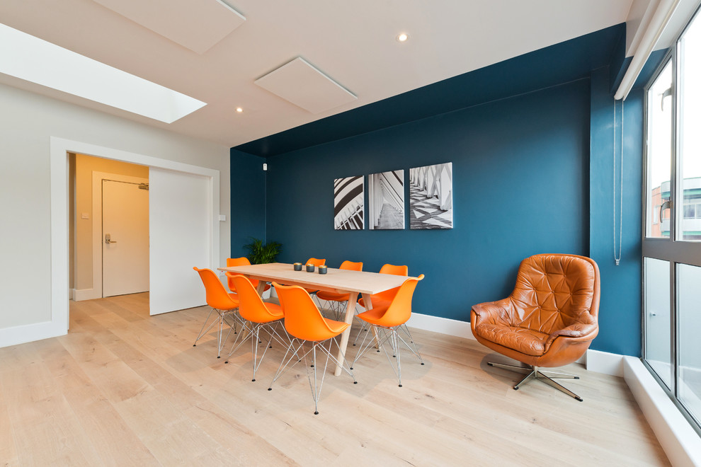 Photo of a medium sized scandi open plan dining room in Dublin with multi-coloured walls, laminate floors and no fireplace.