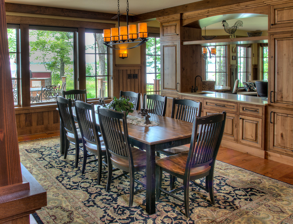 This is an example of a rustic dining room in Minneapolis with beige walls, medium hardwood flooring and brown floors.
