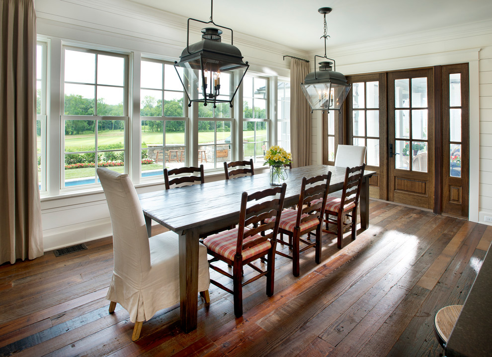 Inspiration for a country enclosed dining room in Nashville with beige walls, dark hardwood flooring and feature lighting.