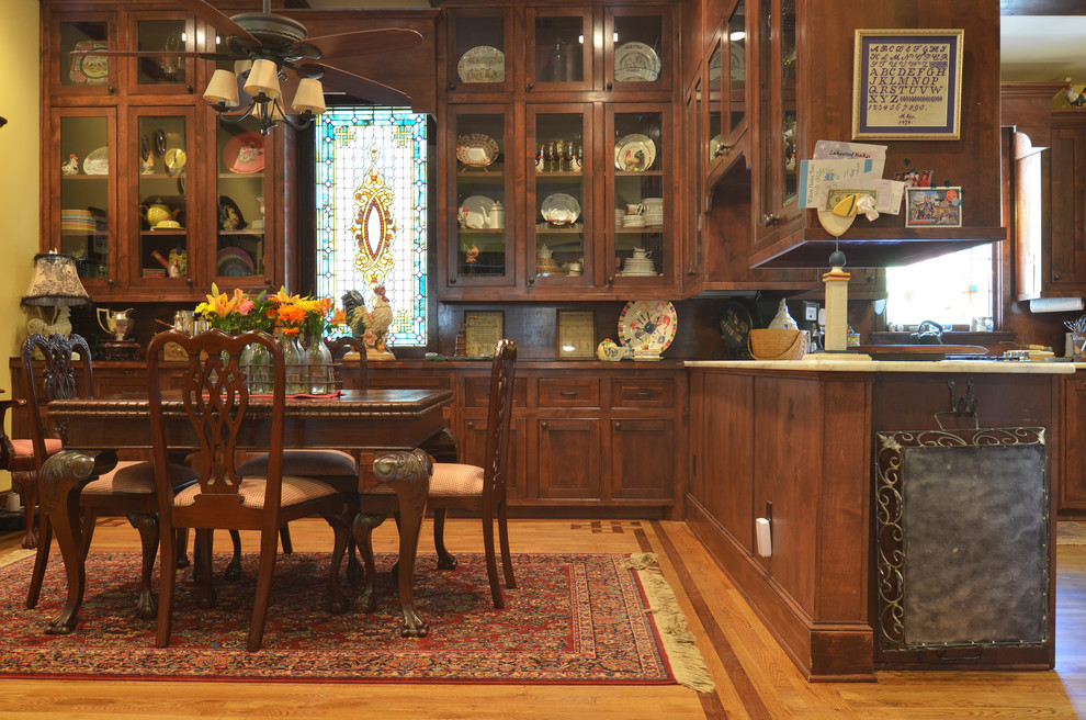 Victorian kitchen/dining room in Dallas with medium hardwood flooring.