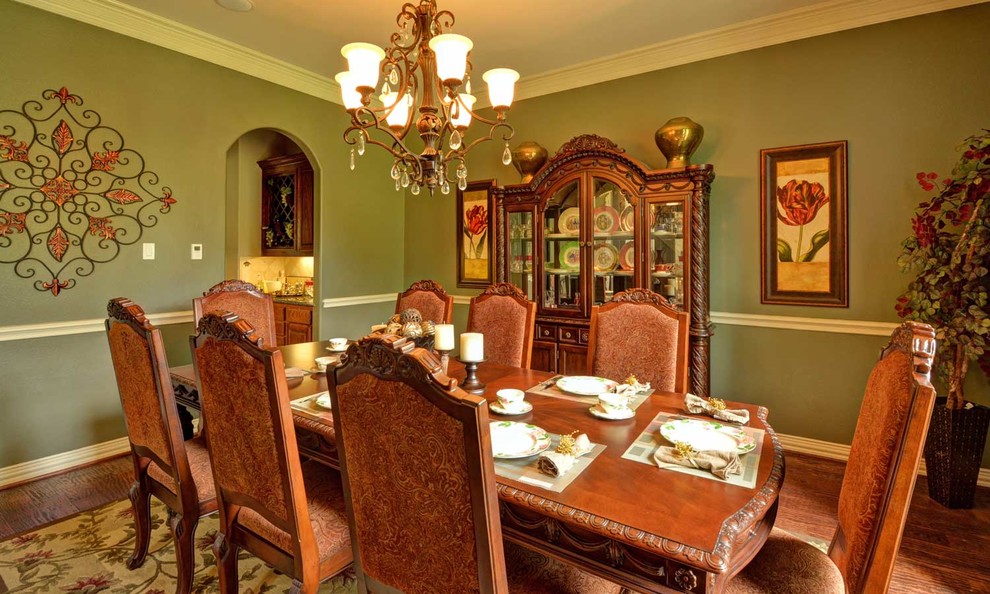 Medium sized traditional enclosed dining room in Dallas with green walls, dark hardwood flooring and no fireplace.