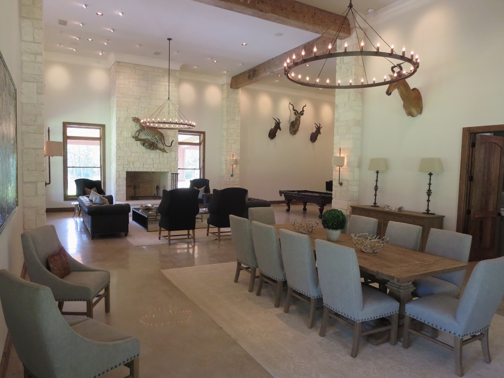 Стильный дизайн: большая гостиная-столовая в стиле рустика с серыми стенами, бетонным полом, стандартным камином и фасадом камина из камня - последний тренд